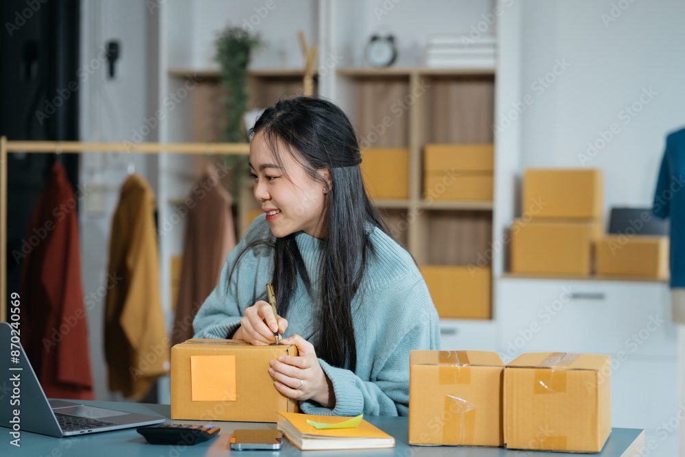 Woman start up online seller owner at workplace. small business entrepreneur SME or freelance asian woman working with box at home. Woman start up online seller owner at workplace. small business entrepreneur SME or freelance asian woman working with box at home.