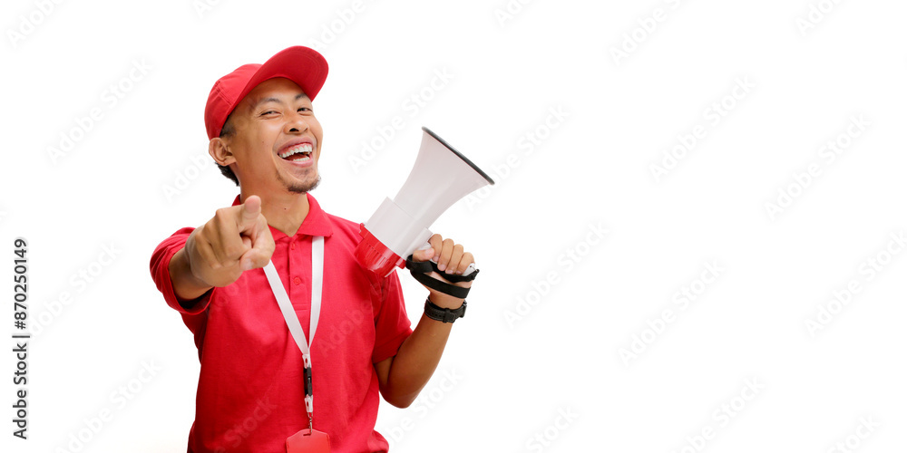 Excited Asian delivery man or courier in a red delivery uniform, wearing a red cap and polo shirt, pointing at the camera while holding a megaphone, isolated on a white background Excited Asian delivery man or courier in a red delivery uniform, wearing a red cap and polo shirt, pointing at the camera while holding a megaphone, isolated on a white background