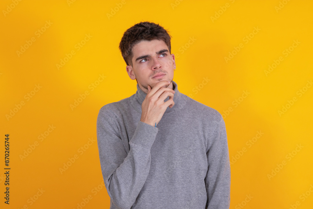 young man isolated on background thinking young man isolated on background thinking