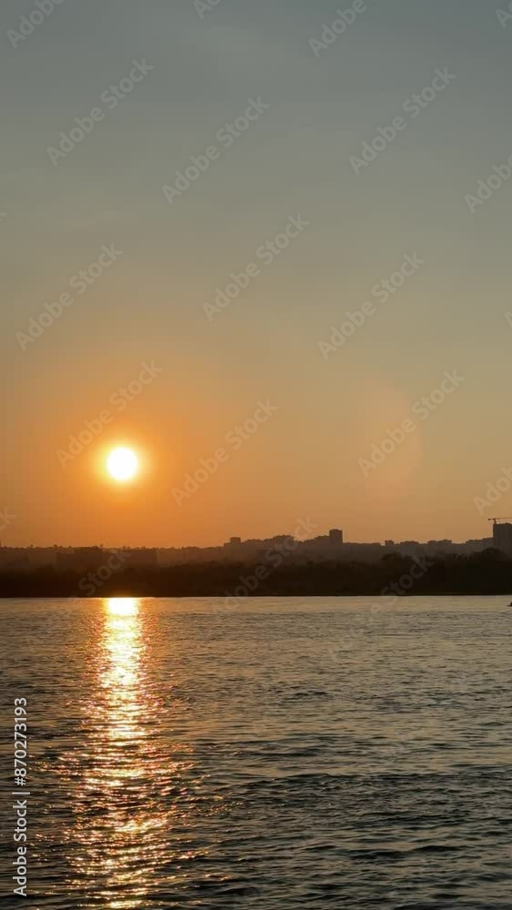 View of the city from the river at sunset. Static vertical 4K footage View of the city from the river at sunset. Static vertical 4K footage
