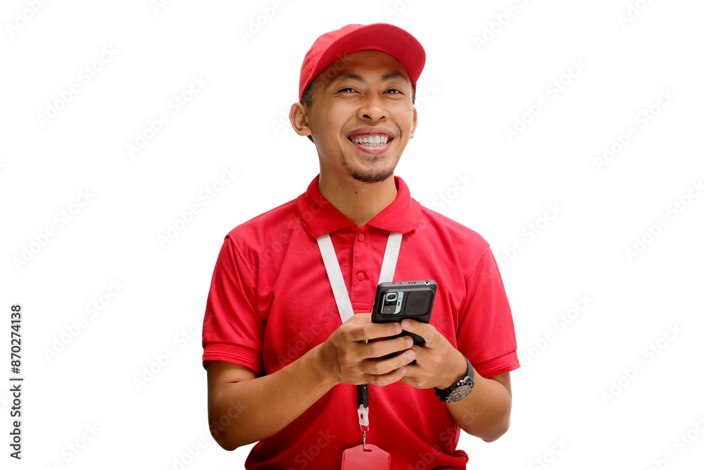 A cheerful Asian delivery man or courier smiling while holding a phone. Isolated on a white background A cheerful Asian delivery man or courier smiling while holding a phone. Isolated on a white background