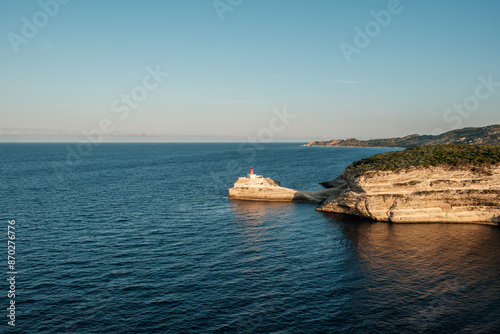 Early morning sun on Phare de la Madonetta, a lighthouse on a limestone promontory at the entrance to the harbour at Bonifacio in Corsica photo