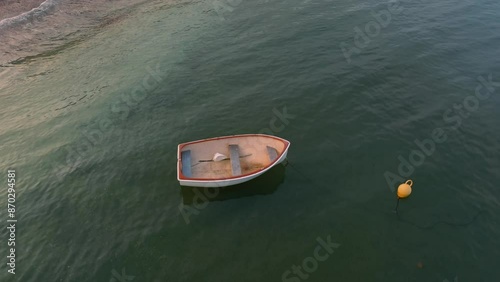 Small dinghy boat sitting in calm ocean waters in Whangaparoa, Auckland, New Zealand.