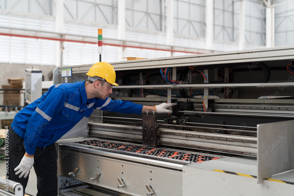 Male engineer repair and maintenance CNC machine in factory. Engineer maintenance machine at workplace. Engineer repair machine in line production Male engineer repair and maintenance CNC machine in factory. Engineer maintenance machine at workplace. Engineer repair machine in line production