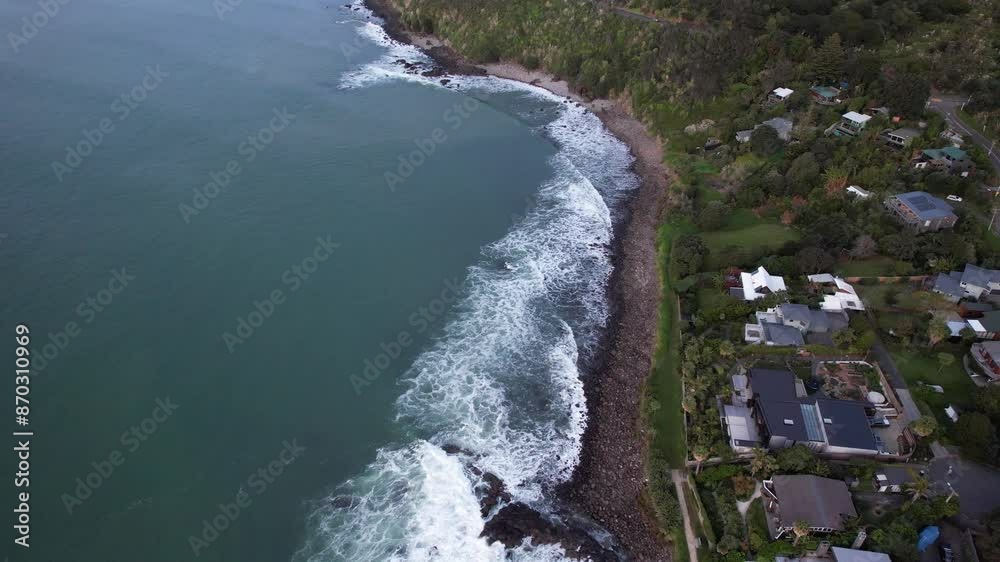 Waves On The Rocky Shore Of Whale Bay Beachfront Paradise Holiday House In Raglan, New Zealand. Aerial Drone Shot