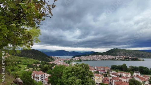 Mountain lake Orestiada in Kastoria city in Greece, cloudy sky in spring photo