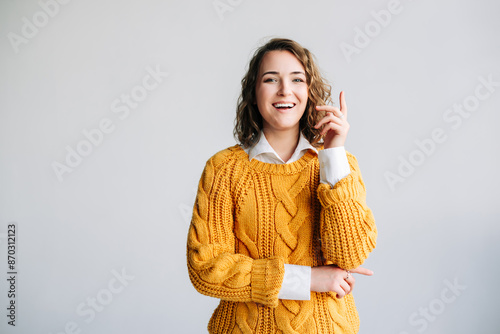 Young Woman Student Has Eureka Moment - Excited, Clever, Pointing Up with New Idea - Wow Promotion Offer Presentation - Conceptual Image of Innovation and Insight - Isolated on White Background