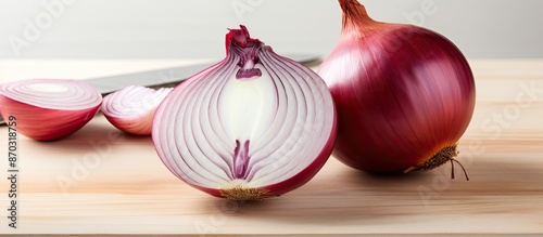 Onion being sliced on a whi...