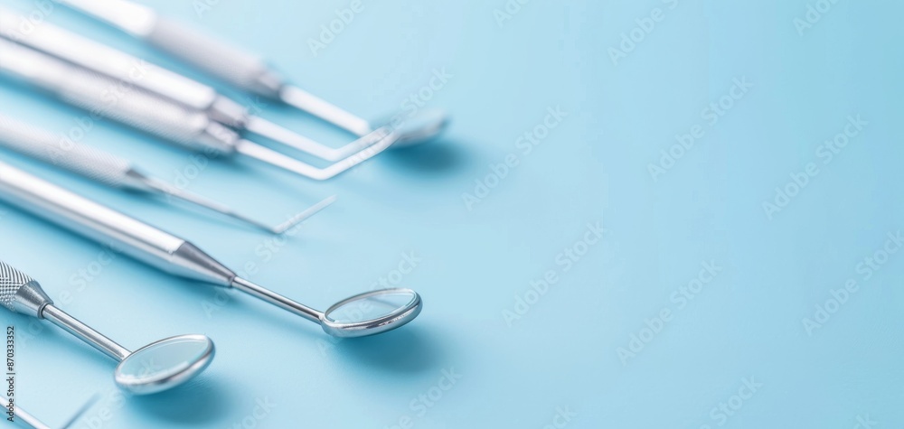 Close-up of dental tools on a light blue background. Perfect for medical, dental health, and clinic-related images. Close-up of dental tools on a light blue background. Perfect for medical, dental health, and clinic-related images.
