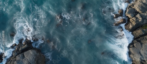 Aerial view of a rocky coastline by the ocean with no people, featuring natural seascape and copy space for images.