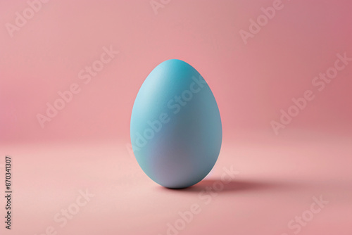 a blue egg on a pink background photo