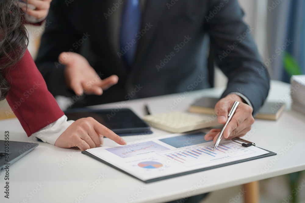 Businessman discusses project planning with colleagues in modern workplace while having discussion and advice on financial report with close-up photo graph document. Businessman discusses project planning with colleagues in modern workplace while having discussion and advice on financial report with close-up photo graph document.