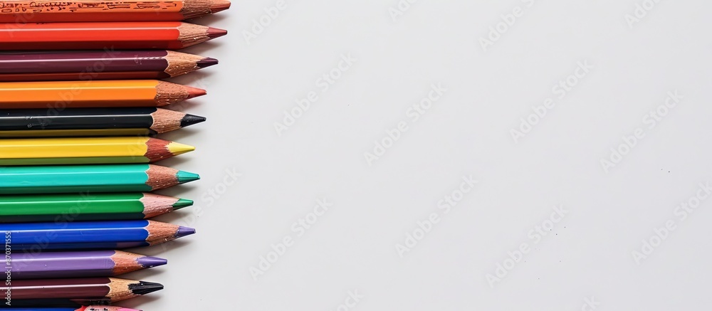 A collection of vibrant pencils in various shades placed near a human hand sketch on a white surface with a horizontal orientation, offering ample copy space for images. A collection of vibrant pencils in various shades placed near a human hand sketch on a white surface with a horizontal orientation, offering ample copy space for images.
