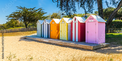 Colored wooden small huts of the beach of La Bree-les-Bains, France in summer
