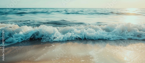 A serene beach scene with gentle ocean waves in the background captured in a copy space image. photo