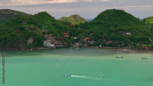 Turquoise bay with lush hills and village in lombok gerupuk, indonesia, aerial view photo