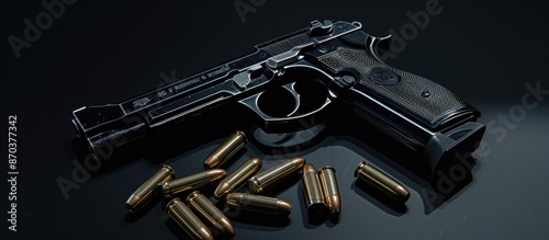 A dark handgun with ammunition, isolated on a background with open space for text or visuals, commonly known as a copy space image.