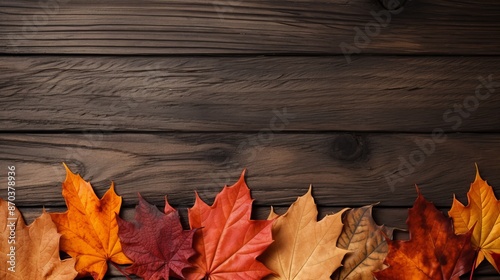 Autumnal leaves on wooden surface, ideal for seasonal backgrounds and textured autumn motifs
