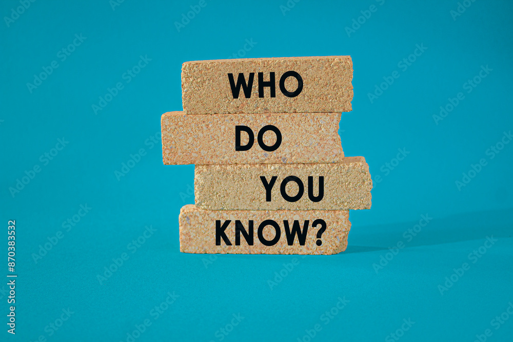 Naklejka premium Who Do You Know symbol. Concept words Who Do You Know on brick blocks. Beautiful blue background. Business and who do you know concept.