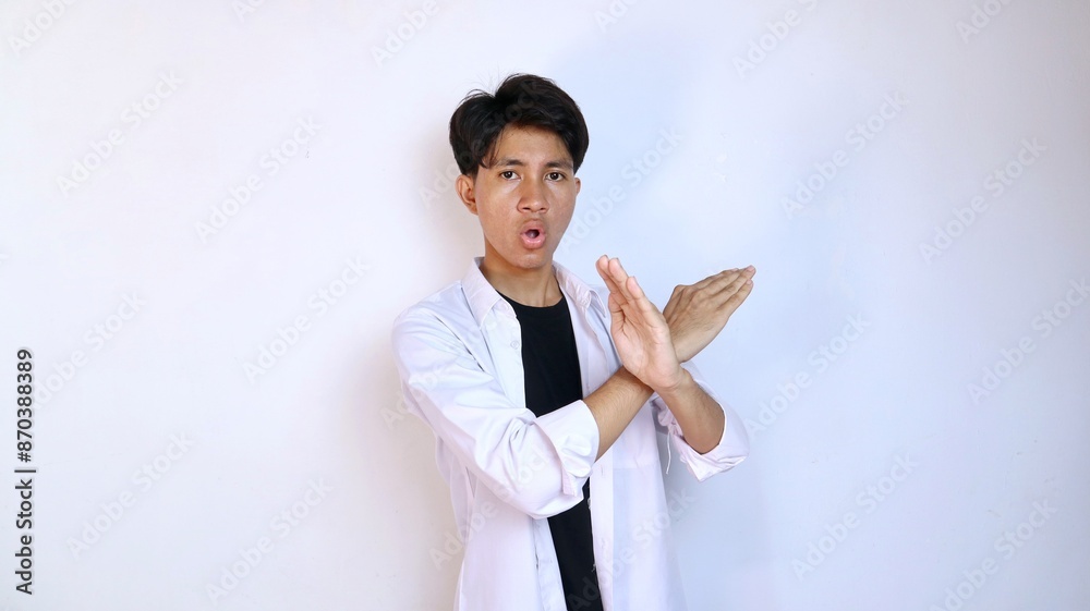 young asian man gesturing with crossed hands, say no, refuse, cancel, prohibited, warning, danger young asian man gesturing with crossed hands, say no, refuse, cancel, prohibited, warning, danger