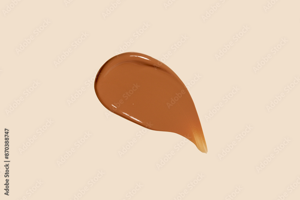 Fototapeta premium Cosmetic concealer or foundation smudge, strokes isolated on nude background