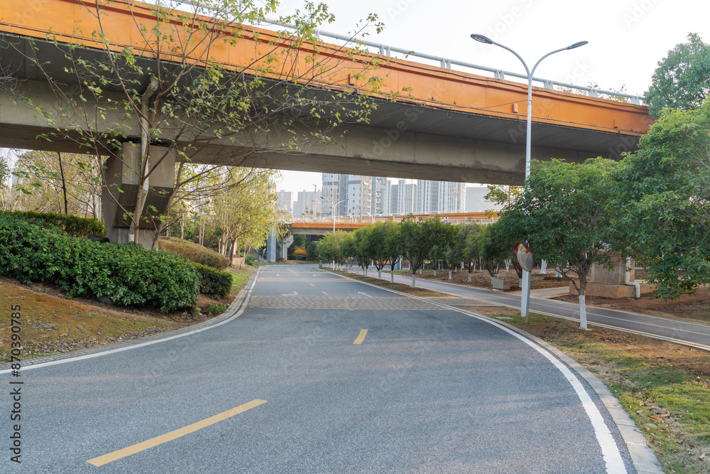Naklejka premium Concrete structure and asphalt road space under the overpass in the city