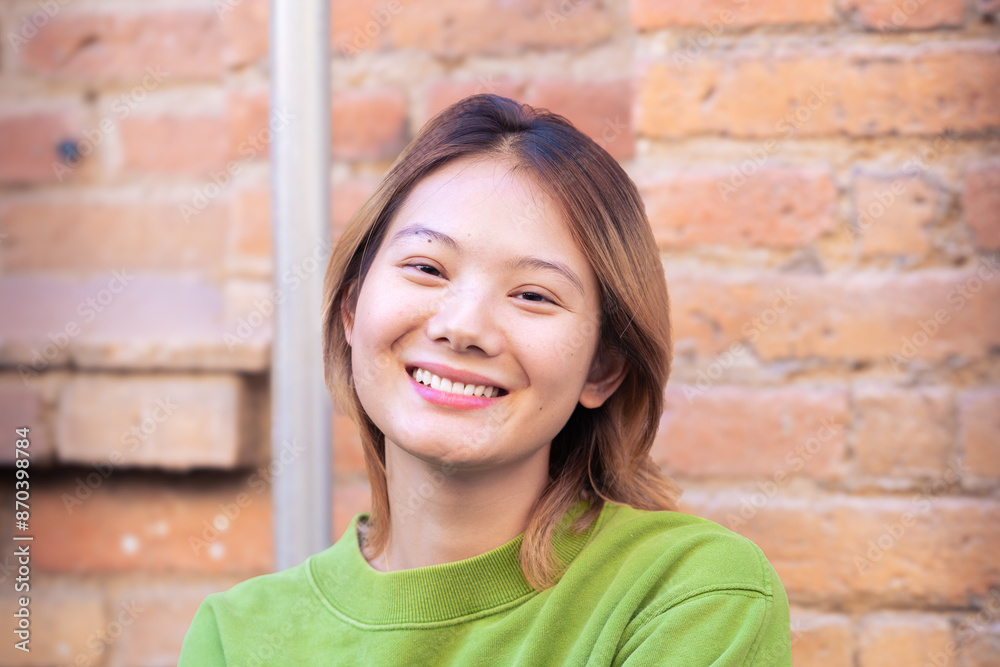 Attractive confident chinese teenage student looking at camera outdoors. Boy standing with happy face. Attractive confident chinese teenage student looking at camera outdoors. Boy standing with happy face.