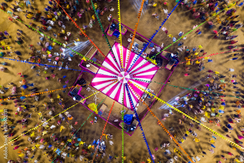 People dance at hindu Navratri festival the traditional Garba dance wearing indian clothes. Spectacular Top down aerial view of indian religious festival