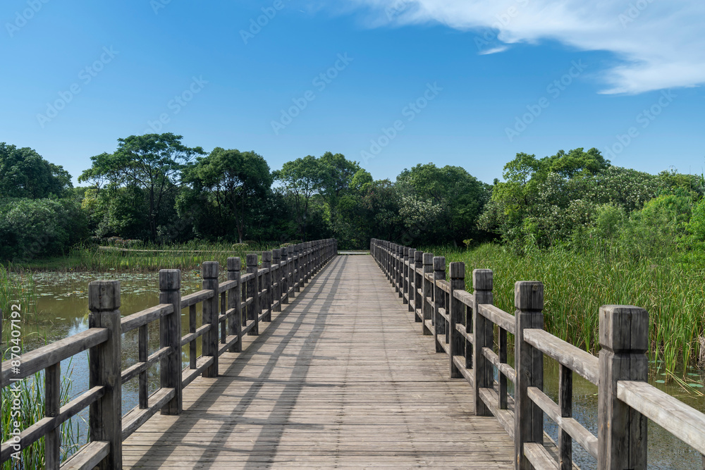 Wooden bridge over little river in city park