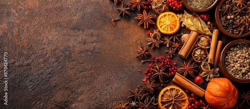Fototapeta Naklejka Na Ścianę i Meble -  A variety of mulled wine spices displayed on a brown surface with room for adding text in a copy space image.