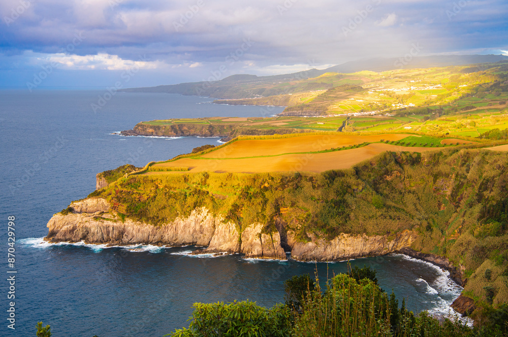 Fototapeta premium Atlantic ocean coastline of São Miguel Island, Azores, Portugal. Stones, rocks and water at sunset. Nature, landscape photography. Golden hour.