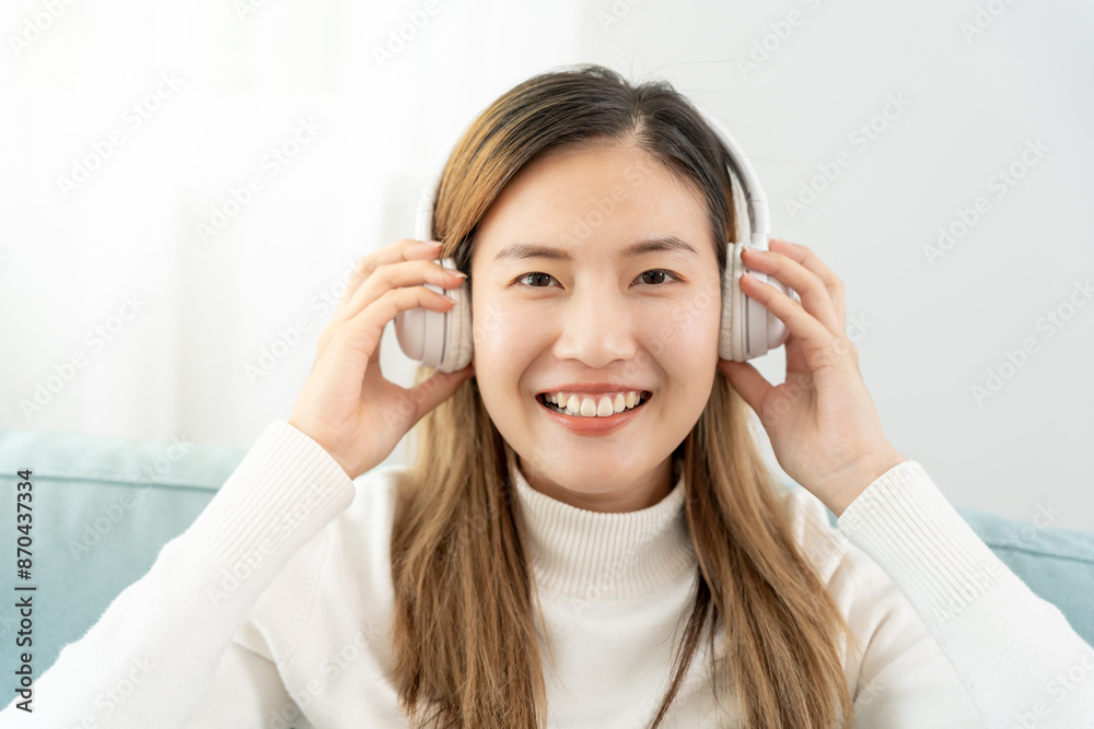 Joyful young Asian women in wireless headphones sitting and enjoy music, having fun, listening to music, raising his arm, dancing to favorite song, enjoying cool soundtrack, happy life, recreation Joyful young Asian women in wireless headphones sitting and enjoy music, having fun, listening to music, raising his arm, dancing to favorite song, enjoying cool soundtrack, happy life, recreation