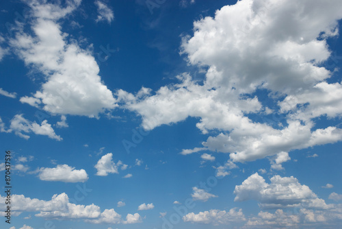 Summer blue blue sky with fluffy cumulus clouds, a natural landscape painting.