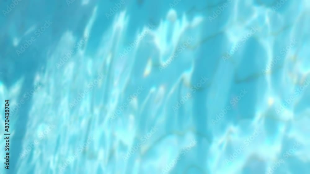 Pure blue water surface in the swimming pool with light reflections ...