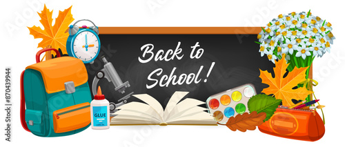 Chalkboard with back to school writing and educational school supplies such as backpack, alarm clock, microscope, glue, open book, paint palette, pencil case and bouquet of flowers with autumn leaves,