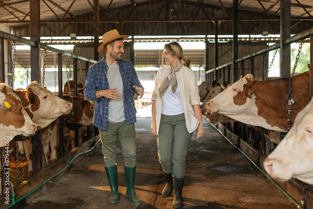 Farmer walking through a barn talking to a pretty blonde woman Farmer walking through a barn talking to a pretty blonde woman