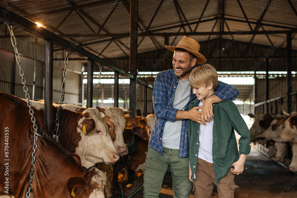 Farmer dad hugging his son and inside a barn Farmer dad hugging his son and inside a barn