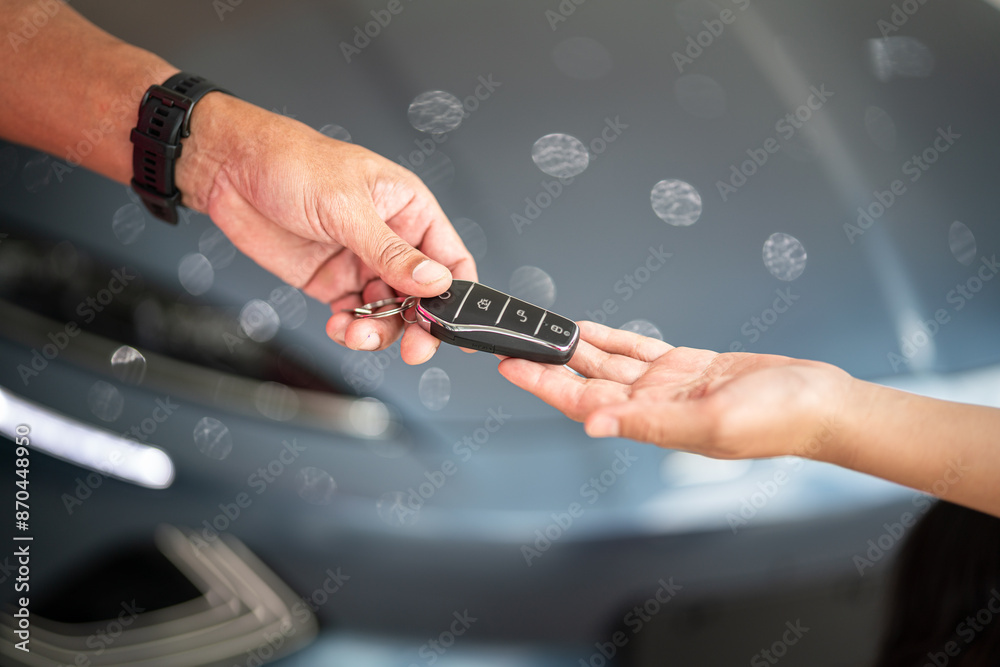 Action of human hands are giving and taking a car key. Buying the new car or car rental business concept scene, Close-up and selective focus at the object. Action of human hands are giving and taking a car key. Buying the new car or car rental business concept scene, Close-up and selective focus at the object.