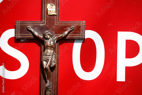 Fotografía Crucifix and stop sign. Anti-religious concept France.