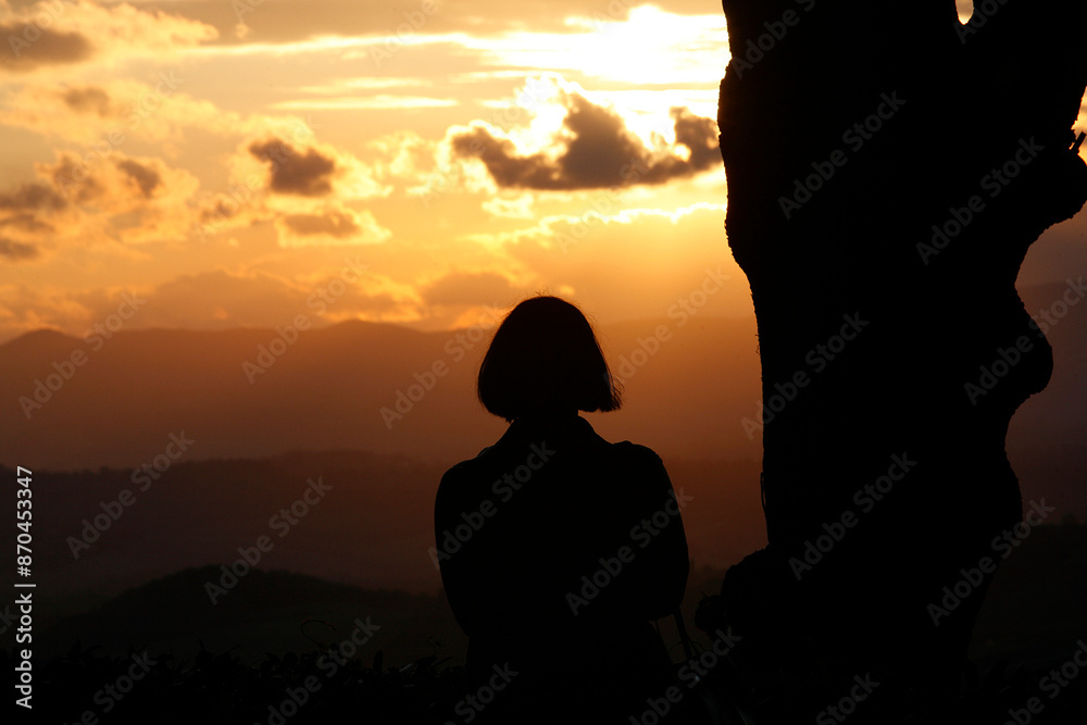 Woman looking at an orange sky. Sunset. Italy. Woman looking at an orange sky. Sunset. Italy.