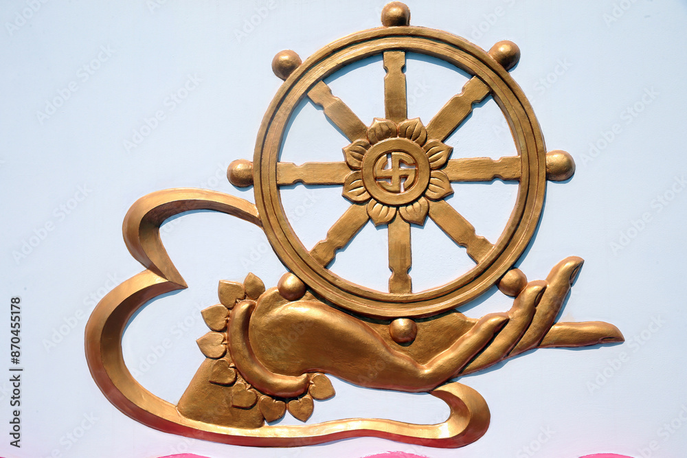 Obraz premium Chua Thien Lam Go buddhist pagoda. Hand with Dharma Wheel. Dharmachakra, the Buddhist eight-fold path illustrated in a wheel. Thay Ninh. Vietnam.