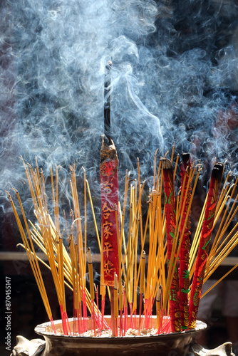 Taoist temple. Phuoc An Hoi Quan Pagoda. Incense sticks on joss stick pot are burning and smoke use for pay respect to the Buddha. photo