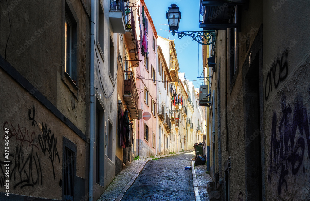 Fototapeta premium View of steep narrow Lisbon streets at medieval quarter Alfama