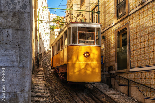 Famous vintage yellow tram  in the narrow streets of Alfama district in Lisbon, Portugal
