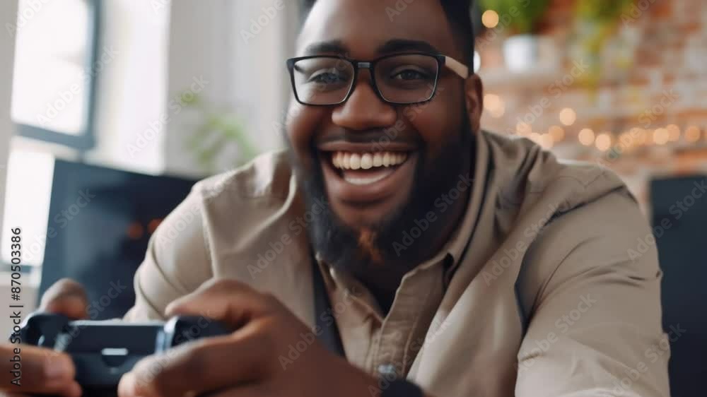 Happy african office employee playing console games enjoying free time team up tension free time activity friend competition colleagues break joystick sitting on couch sofa living room excited play Happy african office employee playing console games enjoying free time team up tension free time activity friend competition colleagues break joystick sitting on couch sofa living room excited play
