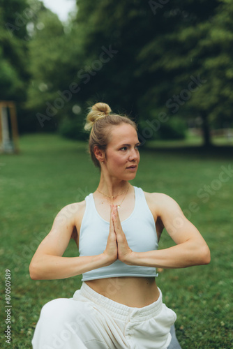 young woman athlete in sportswear practices yoga, enjoys training © Екатерина Лукашина