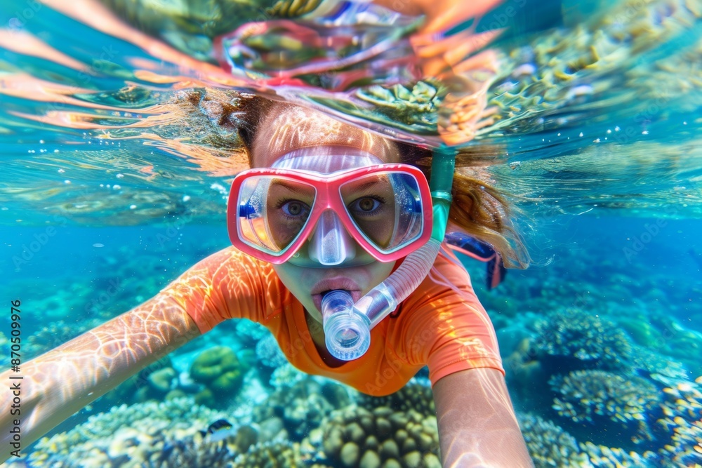 Naklejka premium Underwater selfie of a woman snorkeling in tropical waters