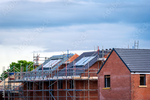 Photovoltaic solar panels on the roof of new built house in england uk. The concept of a sustainable environment, construction