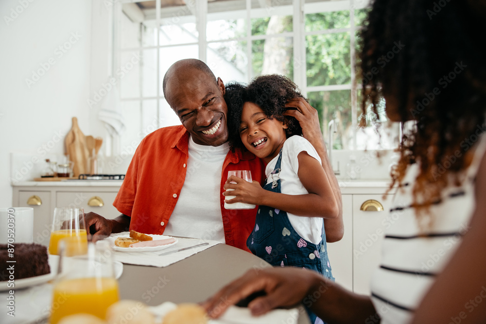 Family moment - Father hugging daughter at breakfast Family moment - Father hugging daughter at breakfast