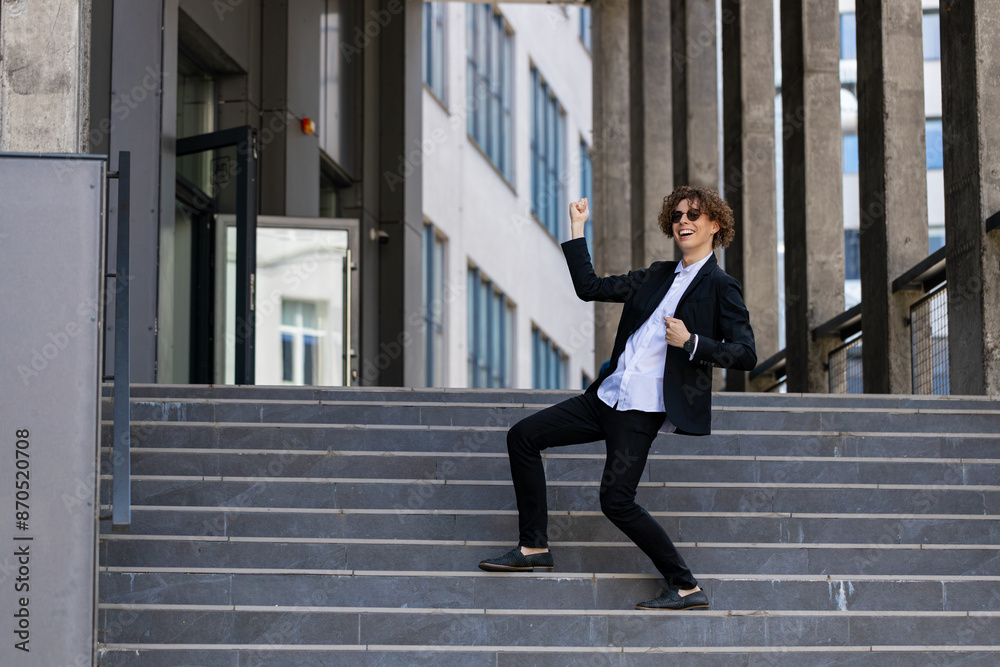 Dance, success or businessman in celebration at steps walking after a job interview, promotion or corporate deal. Excited, or happy dancing employee celebrates sales goals or target in downtown city. Dance, success or businessman in celebration at steps walking after a job interview, promotion or corporate deal. Excited, or happy dancing employee celebrates sales goals or target in downtown city.